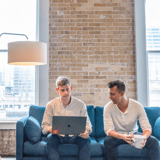 Two people working on a couch